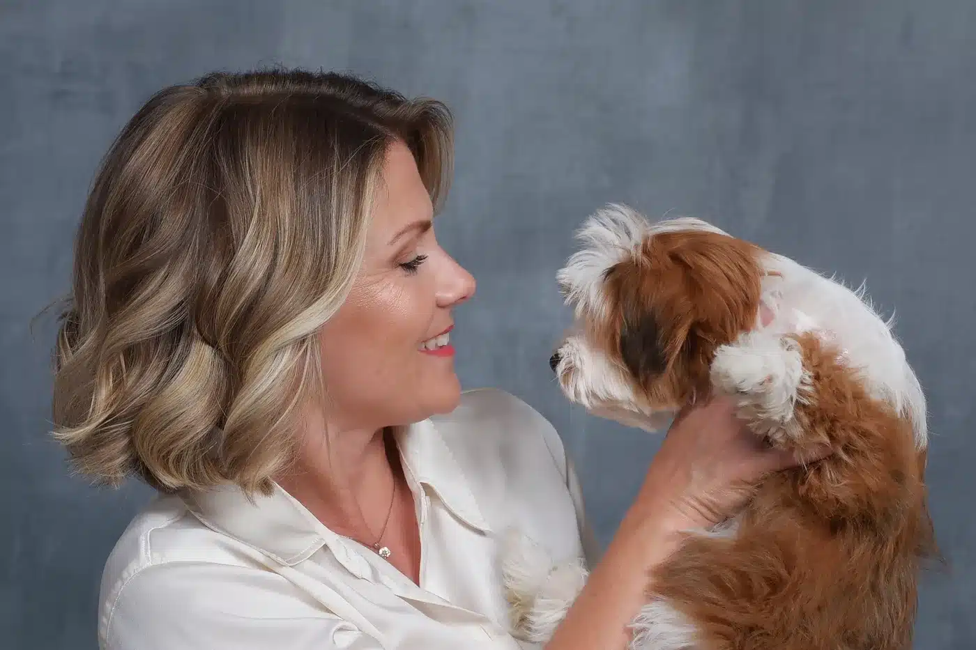 Cassie Milar holding a red and white Havapoo puppy